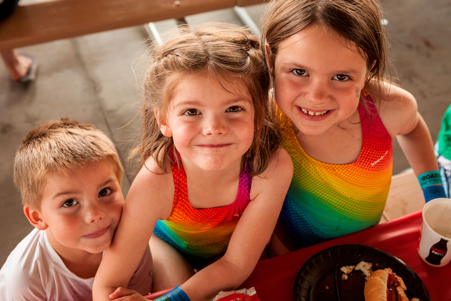 Two young girls and a boy eating