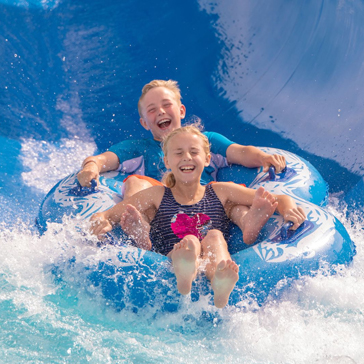 kids laughing on pipe splash