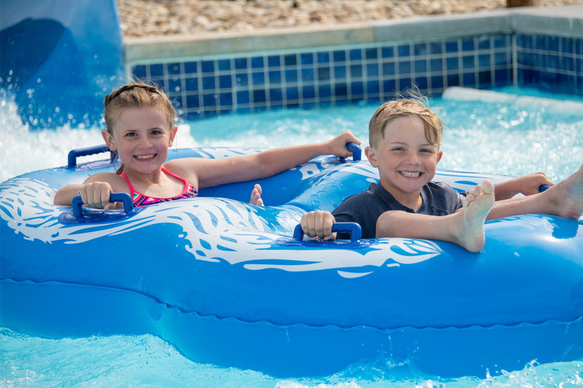 two young kids in blue tube