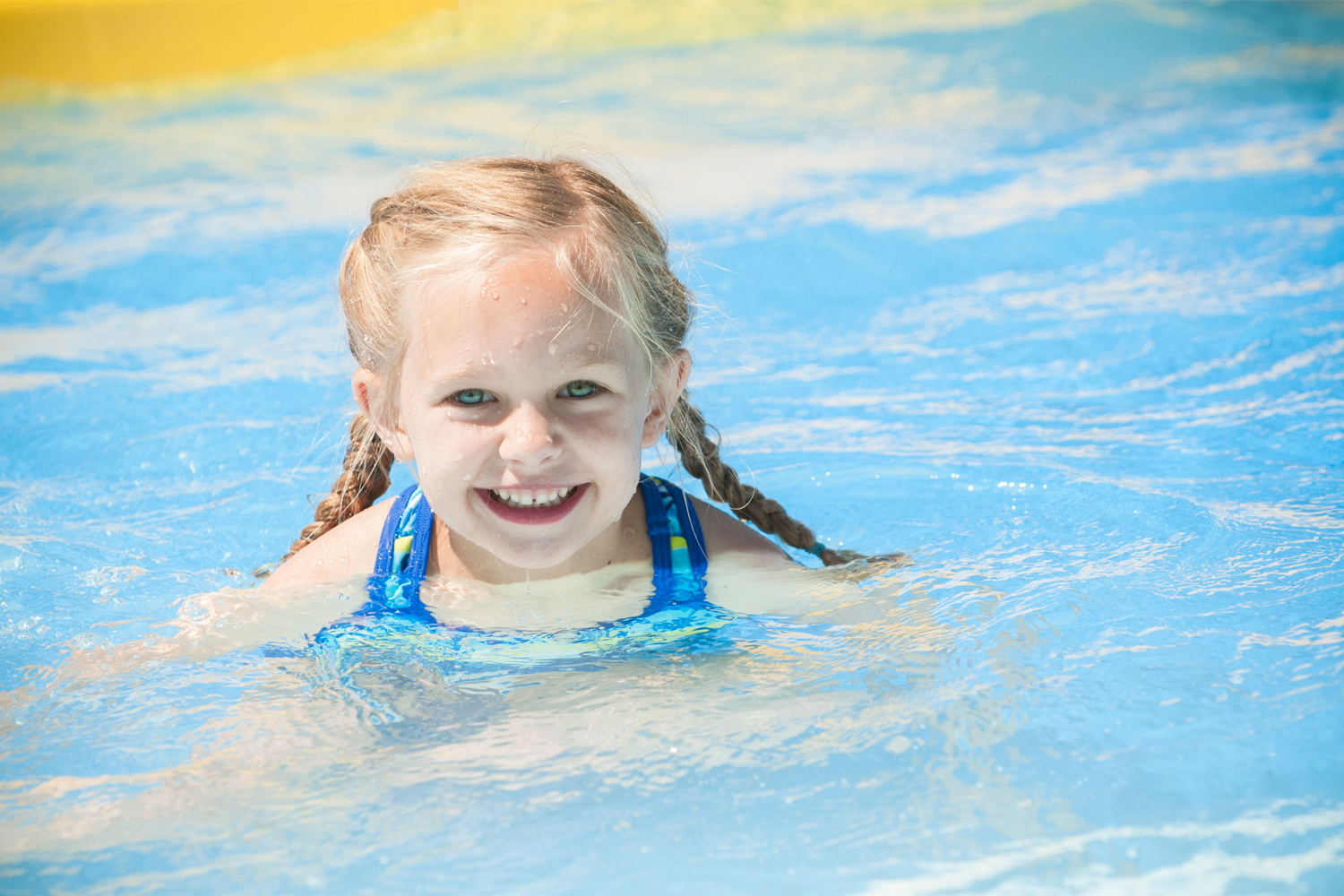 little blonde hiared girl swimming